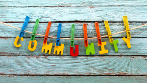Letters of community held up on a line with pegs